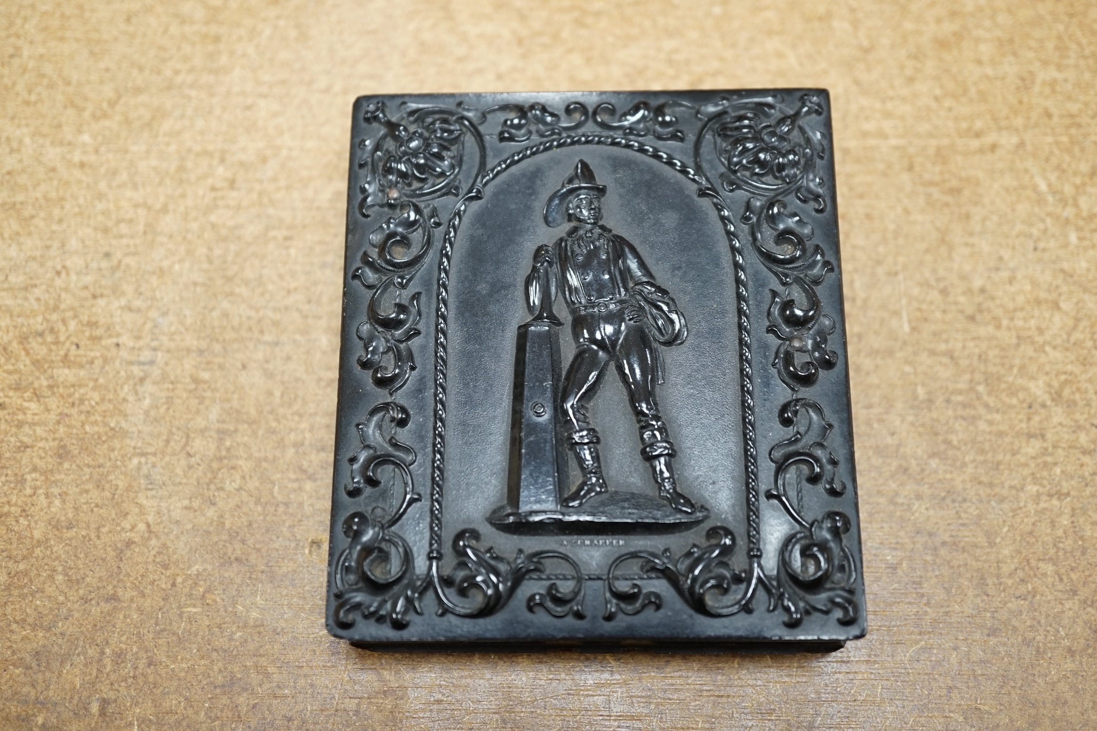 A mid Victorian ambrotype photograph of a gentleman, housed in an original pressed bois durci fireman frame, 9.5cm high. Condition - good